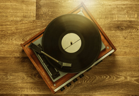 Retro vinyl record player with a record on the floor. 80s. Top viewの写真素材