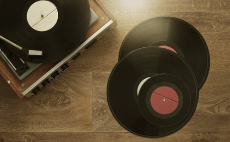 Retro vinyl record player with a records on the floor. 80s. Top view