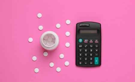 Economic calculation of the cost of treatment, analysis of the cost of medicines. Bottle of pills, calculator on pink background. Top viewの写真素材