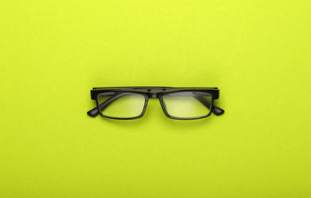 Classic eyeglasses on green background. Top view.の写真素材