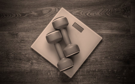 The concept of weight loss, fitness. Floor scales with dumbbells on the floor. Top viewの写真素材
