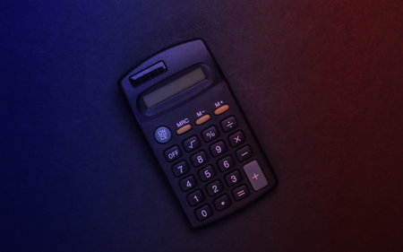 Black calculator in red blue neon light. Top viewの写真素材