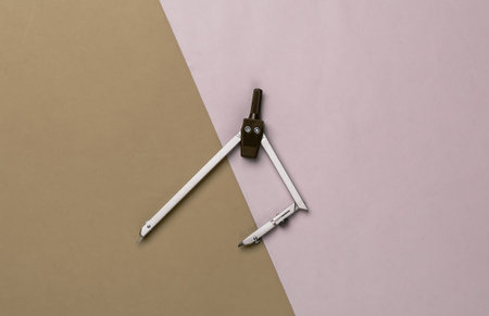 Compass for drawing on colored background. Top view. Stationery. Engineeringの写真素材