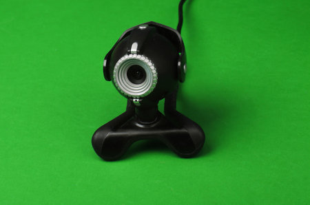 Webcam close-up on green background.