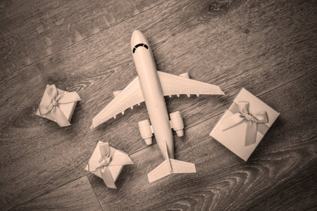 Air delivery. Plane figurine and gift boxes on floor. Flat lay. Top view