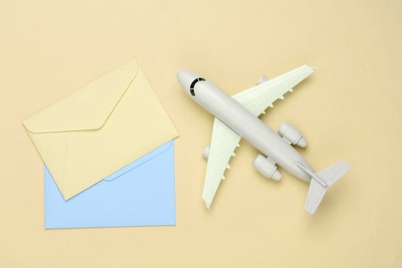Air mail, air delivery. Flat lay composition with an airplane figure and envelopes of letters on...