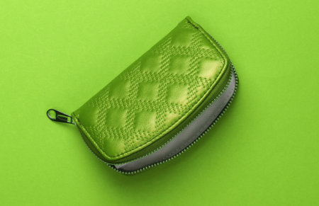 Green open wallet with zipper on Green background. Fashion minimalismの写真素材