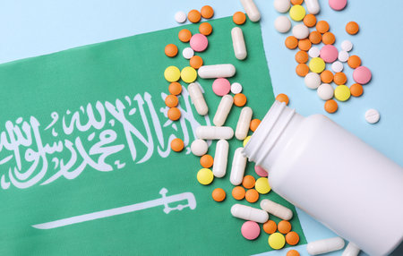 Saudi Arabia flag and pills. Concept of health care