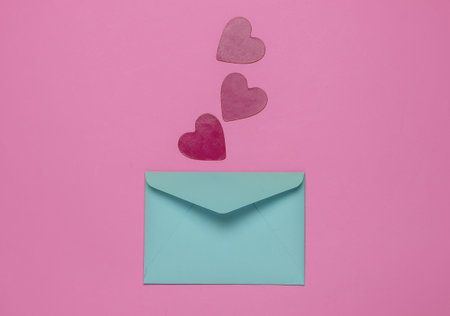 Envelope with decorative hearts on pink background. Flat lay mockup for Valentine's day, wedding or...