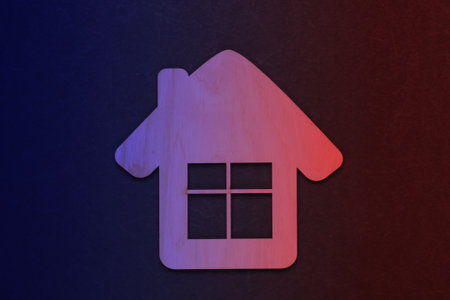 Wooden house figurine or keychain in neon light. Top viewの写真素材