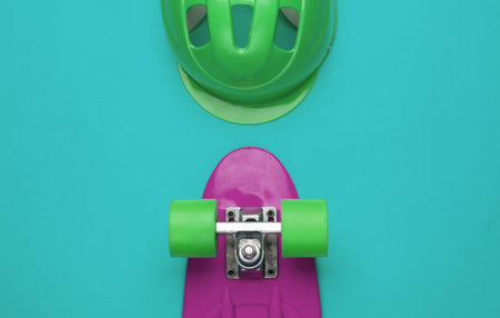 Cruiser board and safety helmet on a blue background. Protective equipment for sports. Childhood. Top viewの写真素材