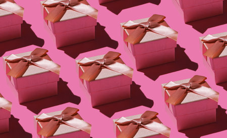 Pop art background. A lot of gift boxes with a bow on pink background. Holiday concept, birthday. Fashion shot with shadowの写真素材