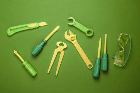 Set of children's toy work tools on green background. Top viewの写真素材