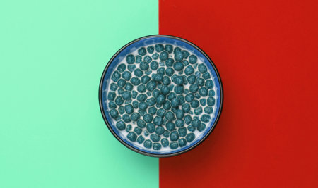 Cereal balls with milk in bowl on colored background. Concept for a healthy diet. Top viewの写真素材