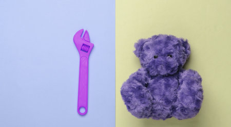 Teddy bear and toy wrench on pastel background. Repair concept. Top viewの写真素材
