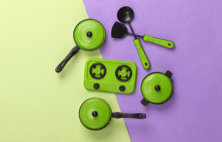 Toy set of children's kitchen on purple green pastel background. Pots, kitchen tools, stove. Top viewの写真素材