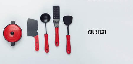 Toy kitchen tools and pan on a white background. Top view. Copy spaceの写真素材