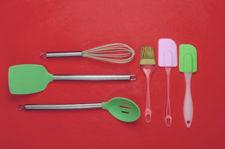 Flat lay compoisition of kitchen tools on Red background. Minimalism. Top view