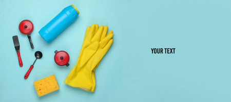 Flat lay composition of dishwashing products, toy kitchen tools and utensils on blue background. Top view. Copy spaceの写真素材