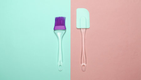 Kitchen tools. Kitchen spatula and brush on pink blue pastel background. Minimalism. Top viewの写真素材