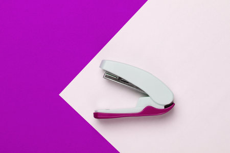 Stapler on colored background. Minimalism. Top view