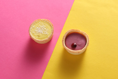 Beautiful delicious cupcakes on pink yellow background.の写真素材