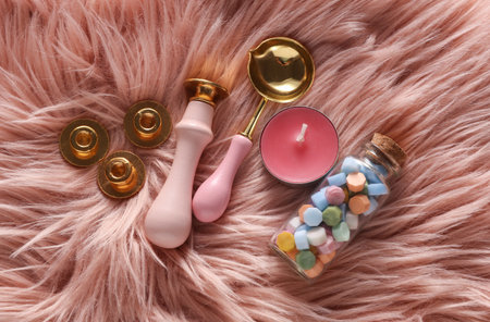 Wax Seal Making Kit on pink fuzzy Background. Top View. Flat Layの写真素材