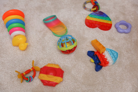 Lots of different toys for little children on the carpet