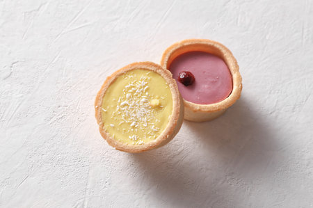 Beautiful delicious cupcakes on white concrete backgroundの写真素材