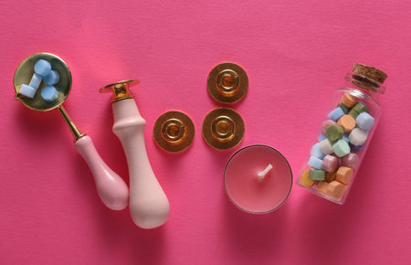Wax Seal Making Kit on pink background. Top View. Flat Lay