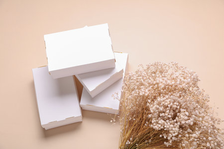 Mockup of White cardboard boxes for product presentation and dry grass on beige background. Creative layoutの写真素材