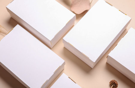 Mockup of White cardboard boxes for product presentation and dry grass on beige background. Creative...