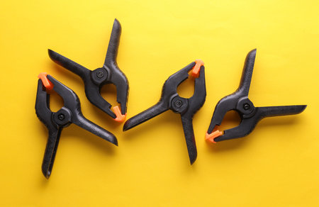 Plastic Spring Clamps on a yellow backgroundの写真素材