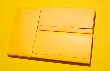 Yellow boxes envelopes on yellow backgroundの写真素材