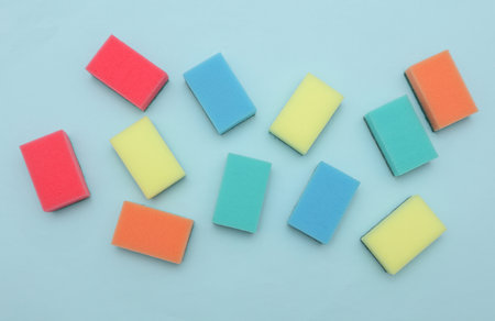 Set of colored cleaning sponges on a blue backgroundの写真素材