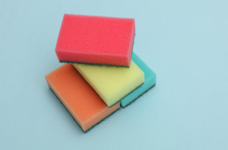 Set of colored cleaning sponges on a blue backgroundの写真素材