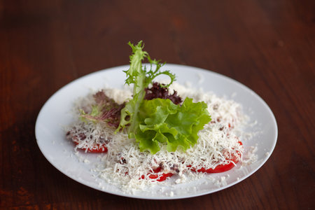 Restaurant dish tomato slices with cheeseの写真素材