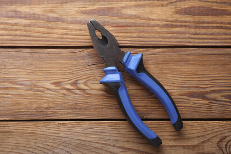 Pliers on a wooden background. Work, repair conceptの写真素材