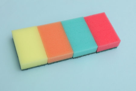Set of colored cleaning sponges on a blue backgroundの写真素材