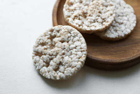 Rice round crackers, diet bread on wooden plate