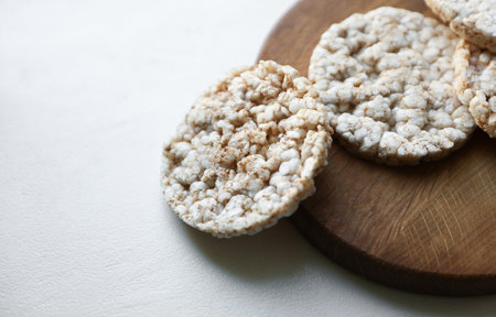 Rice round crackers, diet bread on wooden plate