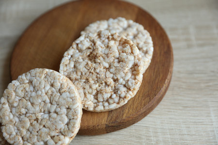 Rice round crackers, diet bread on wooden plate