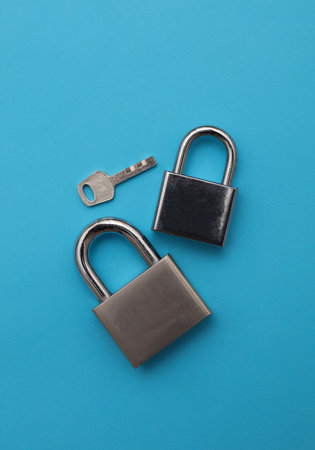 Two metal locks on a blue background