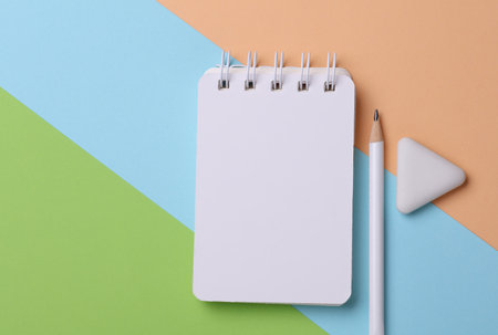 Notepad with school stationery supplies on pink blue backgroundの写真素材