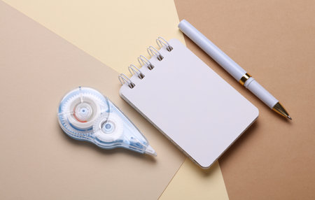 Notepad with school stationery supplies on beige background