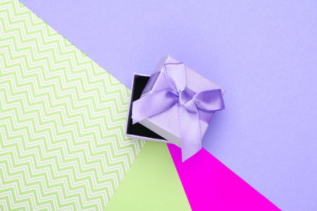 Gift box with bow on a colored background. Pastel color trend. Top viewの写真素材