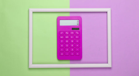 Pink Calculator in a white frame on pink green background. Concept art photo. Top view. Minimalism