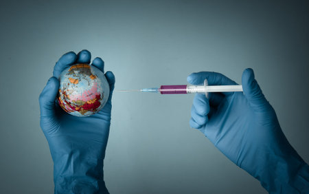 Vaccine against the global pandemic of coronavirus (covid-19). Medic hands in latex gloves hold a...