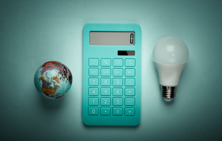 Energy saving. Calculator with led light bulb and globe on blue pastel background. Save planet. Eco...