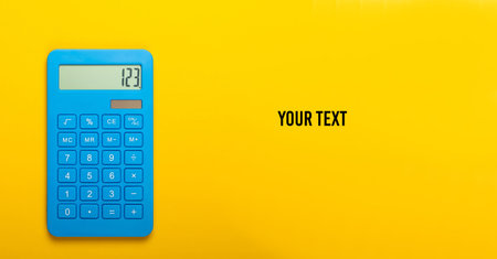 Blue calculator on a yellow background. Calculation or counting. Minimalism. Top view. Copy space